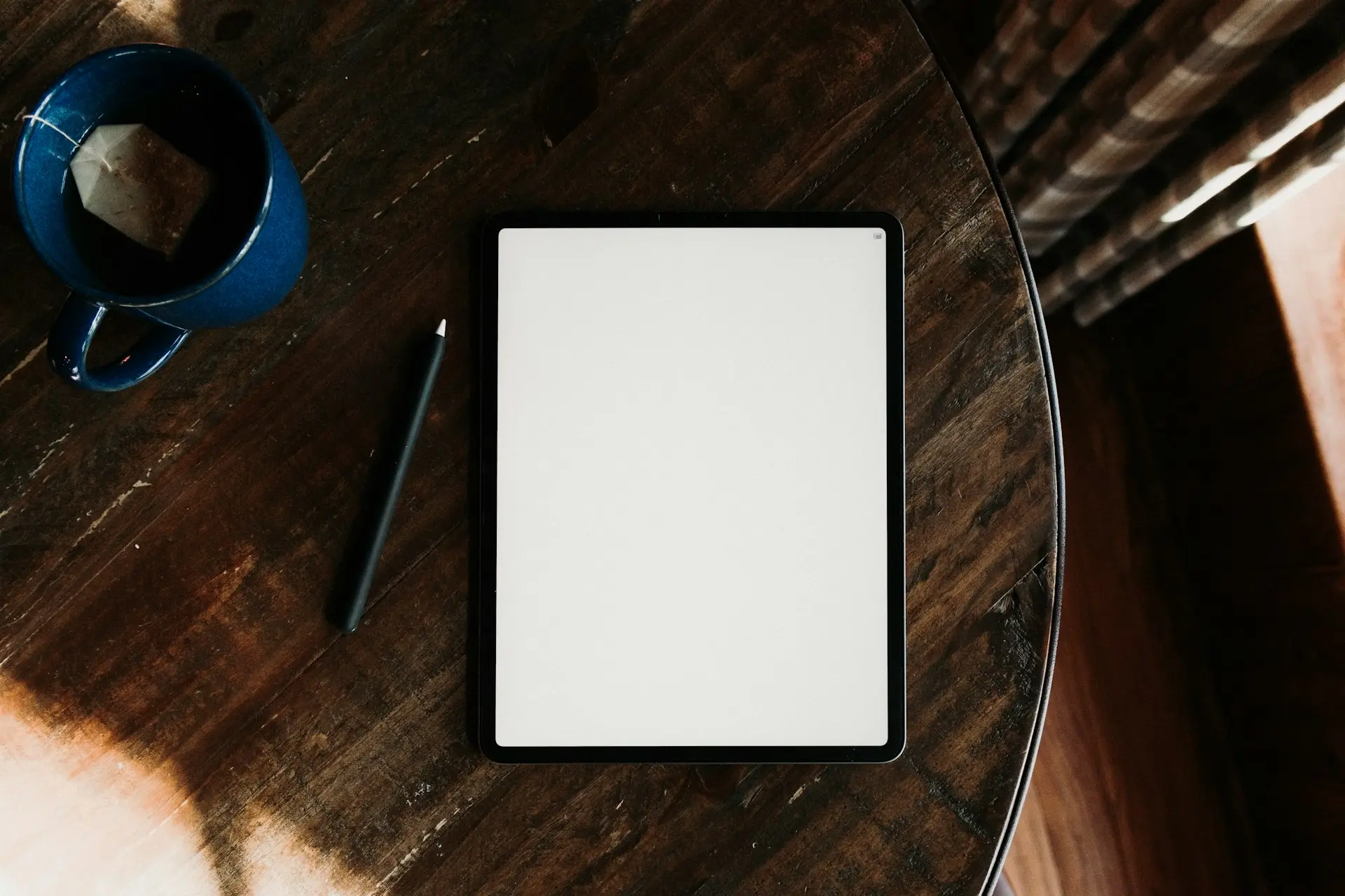 a tablet computer sitting on top of a wooden table